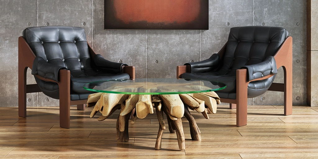 Input: Two dark leather chairs beside a glass table with a timber base