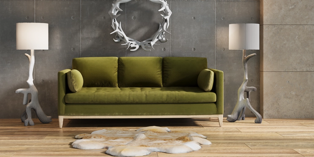 Input: Green sofa between sculptural floor lamps against a concrete wall
